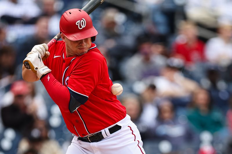 Mar 28, 2023; Washington, District of Columbia, USA; Washington Nationals catcher Riley Adams (15) is hit by a pitch during the eighth inning of the Spring Training game against the New York Yankees at Nationals Park. Mandatory Credit: Scott Taetsch-USA TODAY Sports