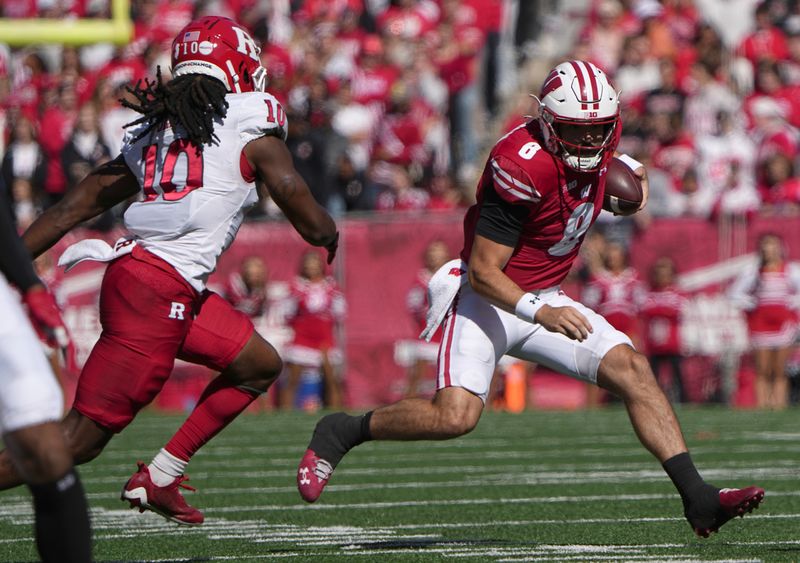 Oct 7, 2023; Madison, Wisconsin, USA; Wisconsin quarterback Tanner Mordecai (8) runs for a first down during the second quarter of their game against Rutgers at Camp Randall Stadium. Mandatory Credit: Mark Hoffman-USA TODAY Sports