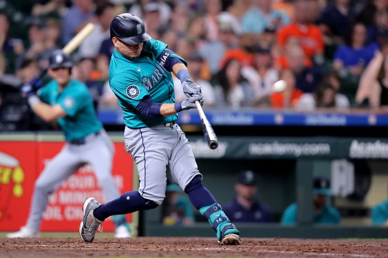 May 4, 2024; Houston, Texas, USA; Seattle Mariners third baseman Luis Urias (16) hits a solo home run to center field against the Houston Astros during the fifth inning at Minute Maid Park. Mandatory Credit: Erik Williams-USA TODAY Sports