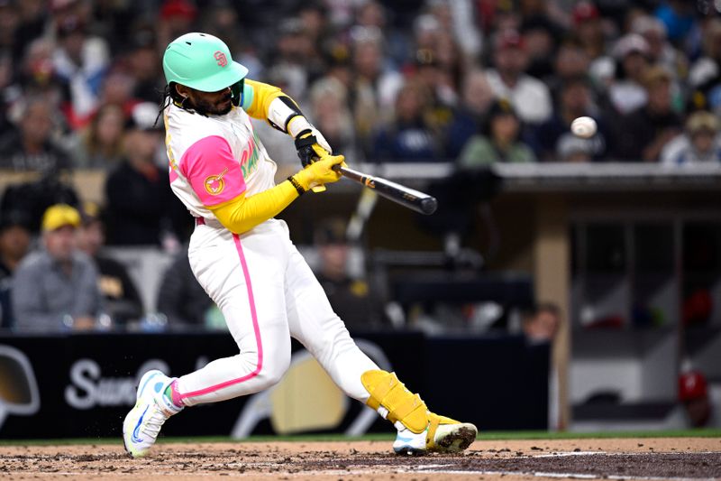 Apr 26, 2024; San Diego, California, USA; San Diego Padres catcher Luis Campusano (12) hits a single against the Philadelphia Phillies during the second inning at Petco Park. Mandatory Credit: Orlando Ramirez-USA TODAY Sports