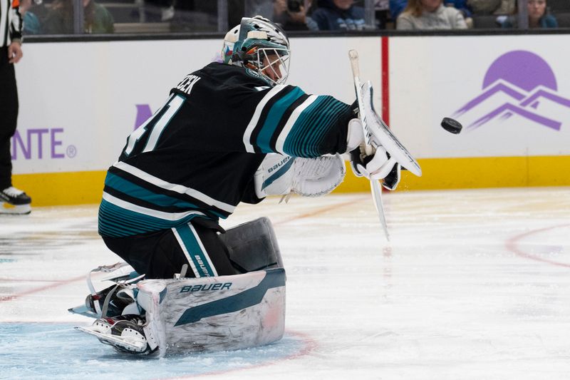 Nov 7, 2024; San Jose, California, USA;  San Jose Sharks goaltender Vitek Vanecek (41) deflects the puck during the first period against the Minnesota Wild at SAP Center at San Jose. Mandatory Credit: Stan Szeto-Imagn Images