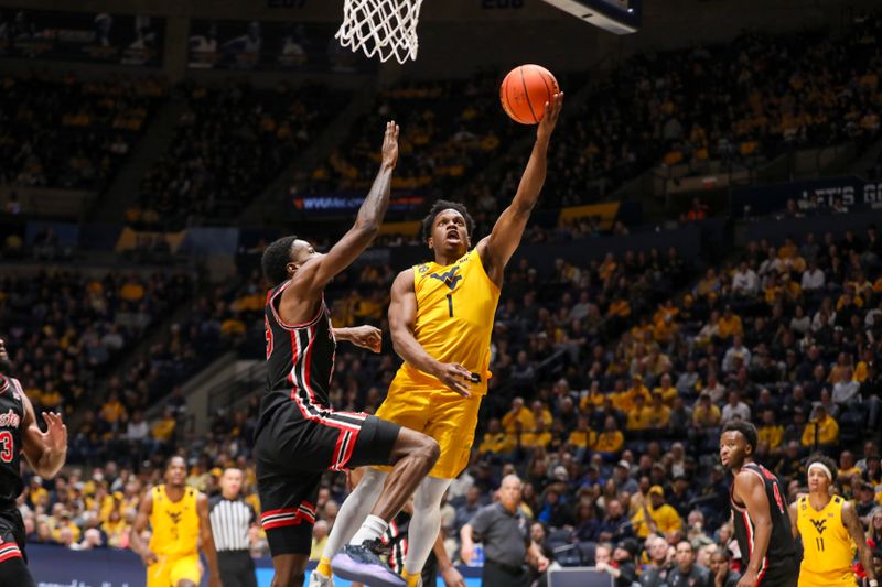 Jan 29, 2025; Morgantown, West Virginia, USA; West Virginia Mountaineers guard Joseph Yesufu (1) shoots against Houston Cougars guard Terrance Arceneaux (23) during the first half at WVU Coliseum. Mandatory Credit: Ben Queen-Imagn Images