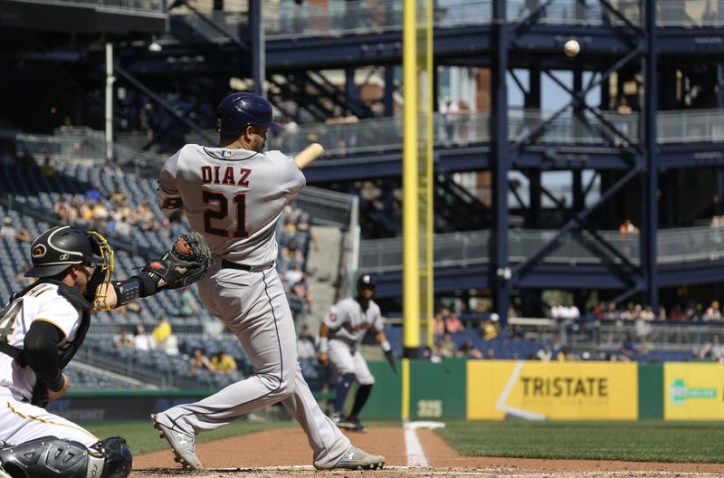 Apr 12, 2023; Pittsburgh, Pennsylvania, USA;  Houston Astros catcher Yainer Diaz (21) hits a sacrifice fly RBI against the Pittsburgh Pirates during the eighth inning at PNC Park. Mandatory Credit: Charles LeClaire-USA TODAY Sports