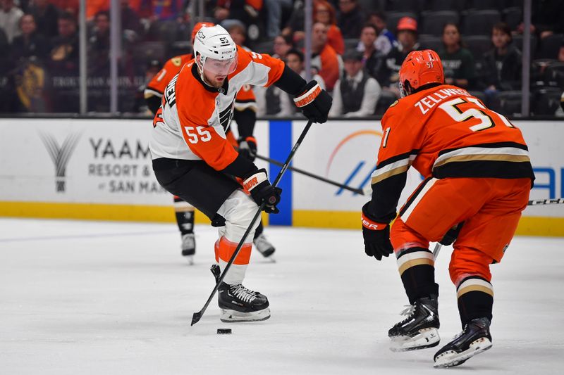 Mar 18, 2026; Anaheim, California, USA; Philadelphia Flyers defenseman Rasmus Ristolainen (55) moves the puck aainst Anaheim Ducks defenseman Olen Zellweger (51) during the first period at Honda Center. Mandatory Credit: Gary A. Vasquez-Imagn Images