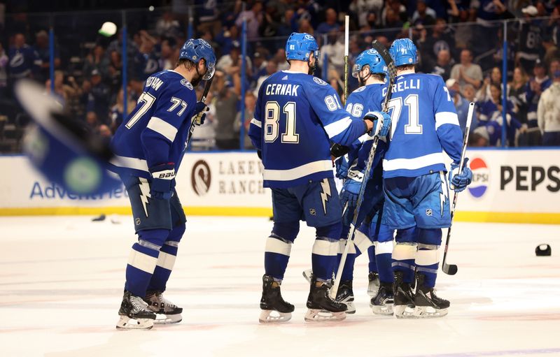 Apr 9, 2024; Tampa, Florida, USA; Tampa Bay Lightning center Steven Stamkos (91) is congratulated after he scored a hat trick and hats are thrown on the ice against the Columbus Blue Jackets during the third period at Amalie Arena. Mandatory Credit: Kim Klement Neitzel-USA TODAY Sports