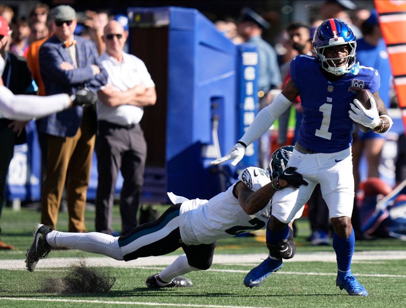 New York Giants wide receiver Malik Nabers (1) carries the ball against Philadelphia Eagles cornerback Darius Slay Jr. (2) during the second quarter of an NFL football game, Sunday, Oct. 20, 2024, in East Rutherford, N.J. (AP Photo/Frank Franklin II)