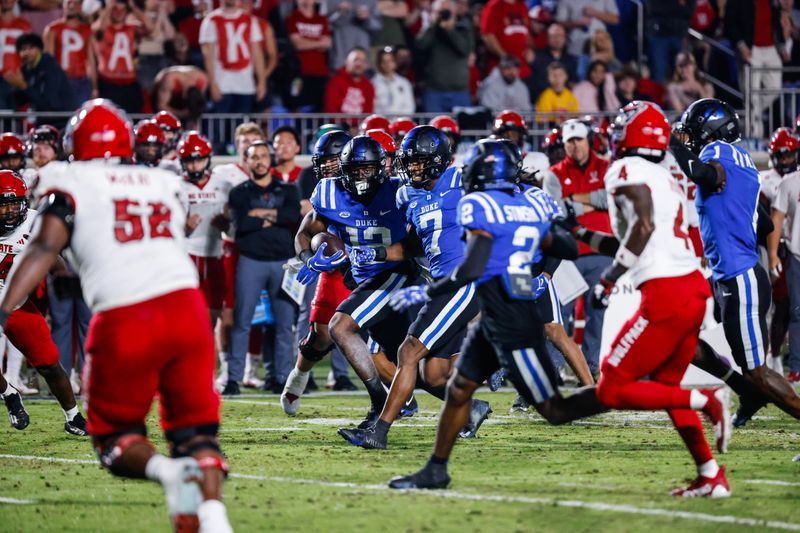 Oct 14, 2023; Durham, North Carolina, USA; Duke Blue Devils quarterback Grayson Loftis (12) runs towards the end zone with the football during the first half of the game against North Carolina State Wolfpack at Wallace Wade Stadium. Mandatory Credit: Jaylynn Nash-USA TODAY Sports