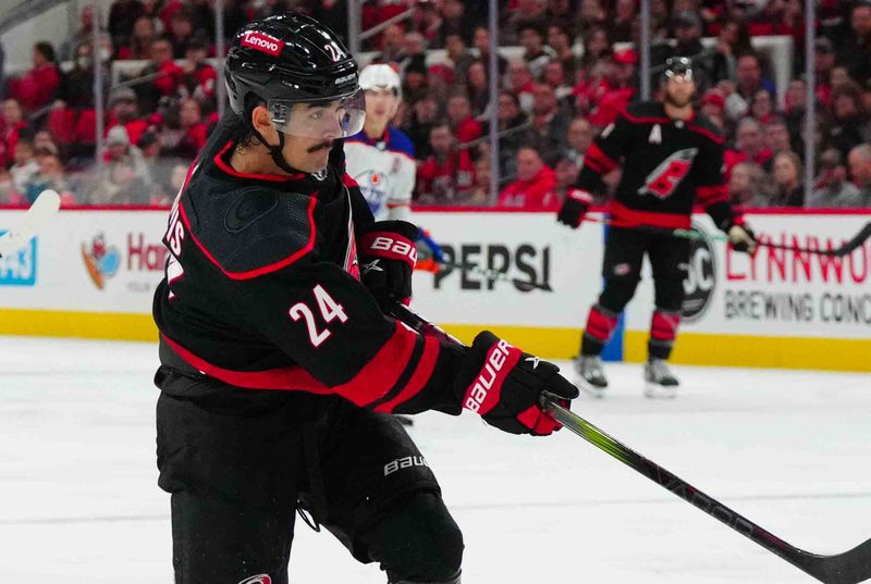 Nov 22, 2023; Raleigh, North Carolina, USA; Carolina Hurricanes center Seth Jarvis (24) takes a shot against the Edmonton Oilers during the third period at PNC Arena. Mandatory Credit: James Guillory-USA TODAY Sports