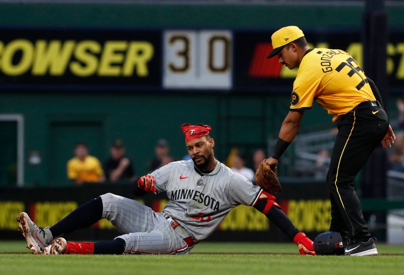 Jun 7, 2024; Pittsburgh, Pennsylvania, USA;  Pittsburgh Pirates second baseman Nick Gonzales (39) confirms a tag out of Minnesota Twins center fielder Byron Buxton (25) in a run down between first base and second base during the sixth inning at PNC Park. Mandatory Credit: Charles LeClaire-USA TODAY Sports