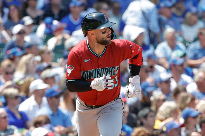 Jul 19, 2024; Chicago, Illinois, USA; Arizona Diamondbacks first baseman Christian Walker (53) watches his two-run single against the Chicago Cubs during the third inning at Wrigley Field. Mandatory Credit: Kamil Krzaczynski-USA TODAY Sports