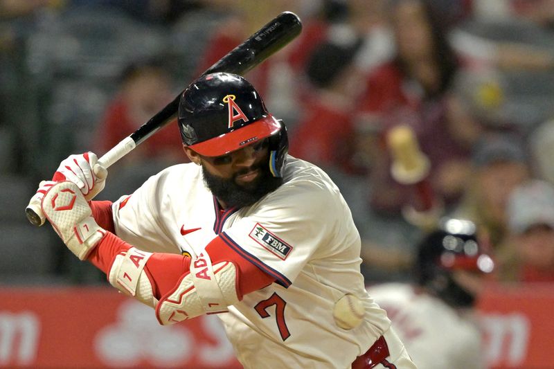 Jul 30, 2024; Anaheim, California, USA; Los Angeles Angels right fielder Jo Adell (7) is hit by a pitch in the eighth inning against the Colorado Rockies at Angel Stadium. Mandatory Credit: Jayne Kamin-Oncea-USA TODAY Sports