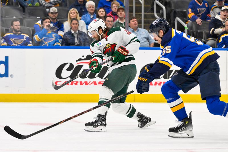 Nov 19, 2024; St. Louis, Missouri, USA;  Minnesota Wild right wing Ryan Hartman (38) shoots and scores against the St. Louis Blues during the first period at Enterprise Center. Mandatory Credit: Jeff Curry-Imagn Images