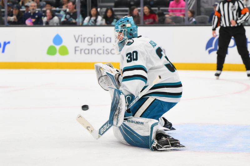 Jan 30, 2025; Seattle, Washington, USA; San Jose Sharks goaltender Yaroslav Askarov (30) blocks a Seattle Kraken goal shot during the first period at Climate Pledge Arena. Mandatory Credit: Steven Bisig-Imagn Images