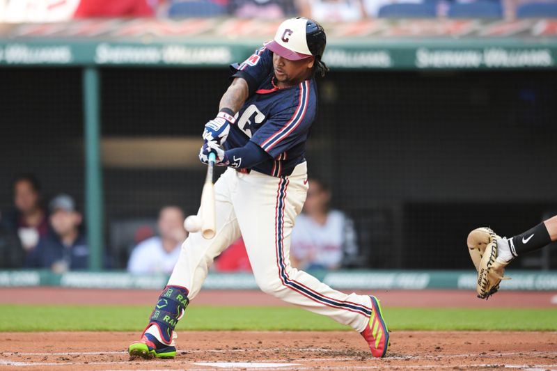 Jul 19, 2024; Cleveland, Ohio, USA; Cleveland Guardians third baseman Jose Ramirez (11) hits a single during the first inning against the San Diego Padres at Progressive Field. Mandatory Credit: Ken Blaze-USA TODAY Sports