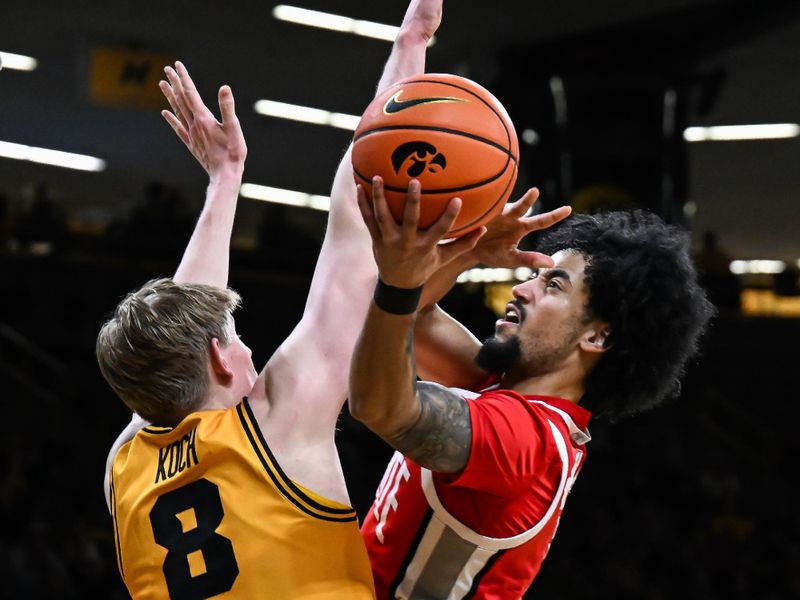 Feb 25, 2026; Iowa City, Iowa, USA; Ohio State Buckeyes guard Taison Chatman (3) goes to the basket as Iowa Hawkeyes forward Cooper Koch (8) defends during the first half at Carver-Hawkeye Arena. Mandatory Credit: Jeffrey Becker-Imagn Images