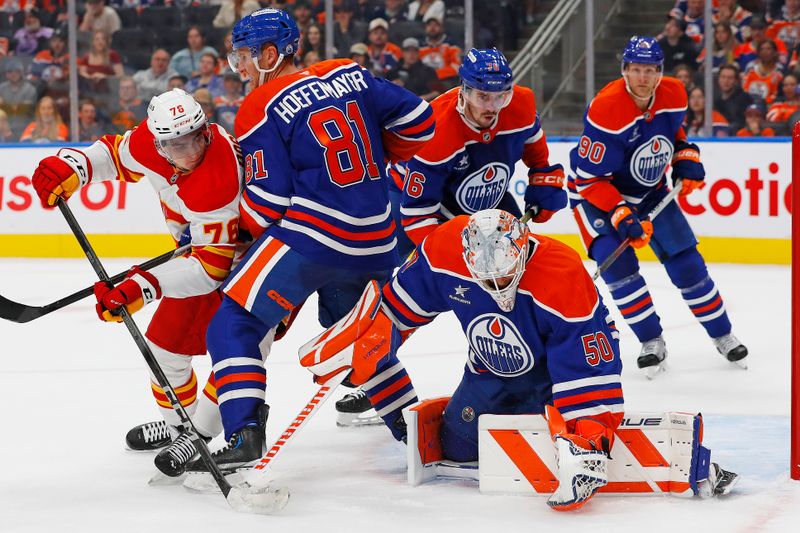 Sep 23, 2024; Edmonton, Alberta, CAN; Calgary Flames forward Martin Pospisil (76) battles with Edmonton Oilers defensemen Noel Hoefenmayer (81) in front of goaltender Brett Brochu (50) during the second period at Rogers Place. Mandatory Credit: Perry Nelson-Imagn Images