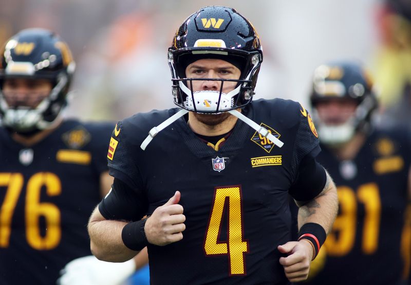 Washington Commanders quarterback Taylor Heinicke (4) is introduced before an NFL football game against the Atlanta Falcons, Sunday, November 27, 2022 in Landover. (AP Photo/Daniel Kucin Jr.)