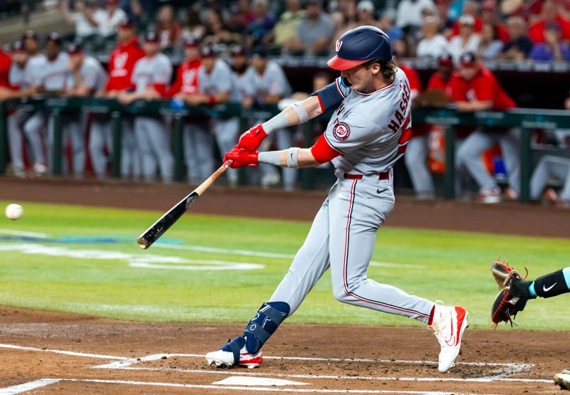 May 30, 2025; Phoenix, Arizona, USA; Washington Nationals outfielder Robert Hassell III hits a two run single in the first inning against the Arizona Diamondbacks at Chase Field. Mandatory Credit: Mark J. Rebilas-Imagn Images