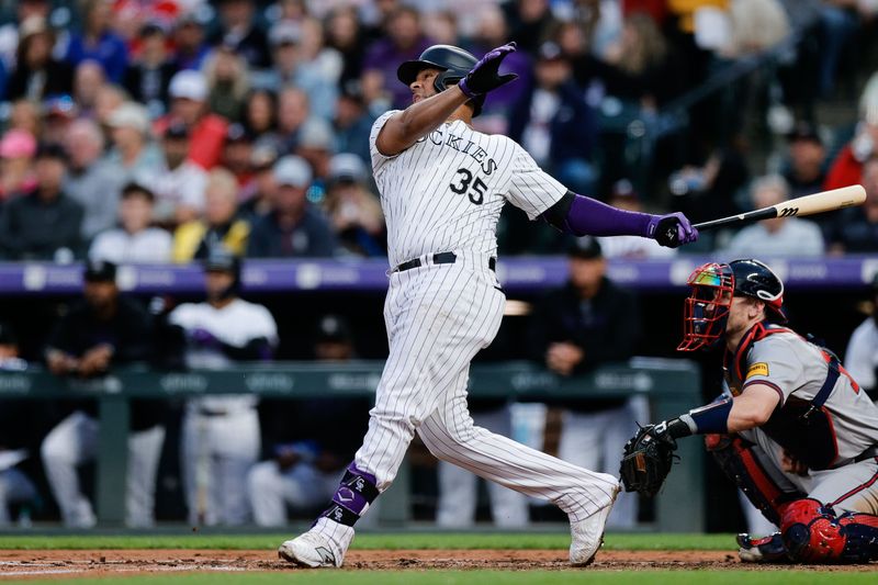 Aug 9, 2024; Denver, Colorado, USA; Colorado Rockies catcher Elias Diaz (35) hits an RBI double in the fourth inning against the Atlanta Braves at Coors Field. Mandatory Credit: Isaiah J. Downing-USA TODAY Sports