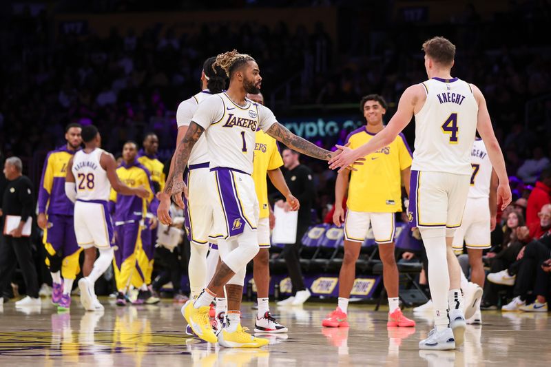 LOS ANGELES, CALIFORNIA - DECEMBER 08: D'Angelo Russell #1 of the Los Angeles Lakers reacts with Dalton Knecht #4 in the second half at Crypto.com Arena on December 08, 2024 in Los Angeles, California. NOTE TO USER: User expressly acknowledges and agrees that, by downloading and or using this Photograph, user is consenting to the terms and conditions of the Getty Images License Agreement. (Photo by Meg Oliphant/Getty Images)