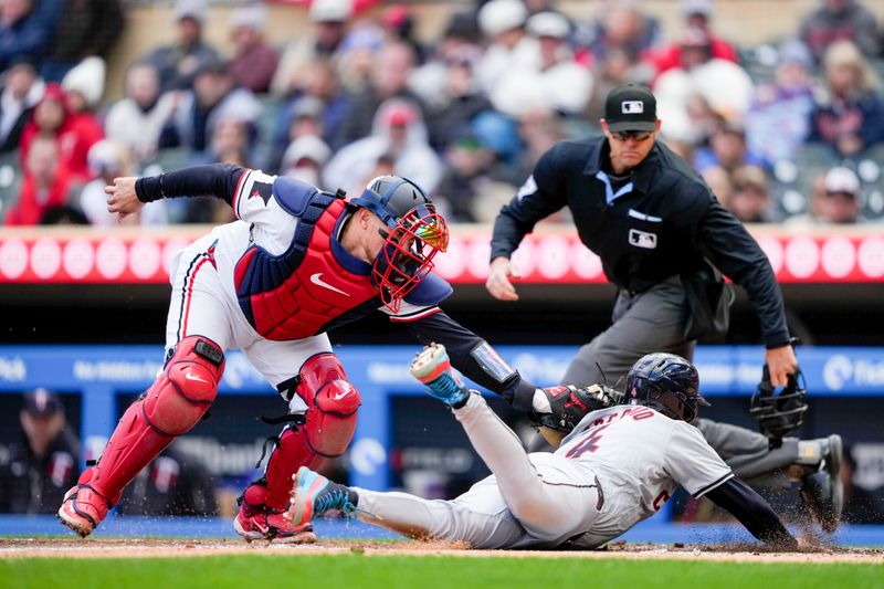 Apr 4, 2024; Minneapolis, Minnesota, USA; Minnesota Twins catcher Christian Vazquez (8) tags out Cleveland Guardians shortstop Brayan Rocchio (4) during the fifth inning at Target Field. Mandatory Credit: Jordan Johnson-USA TODAY Sports