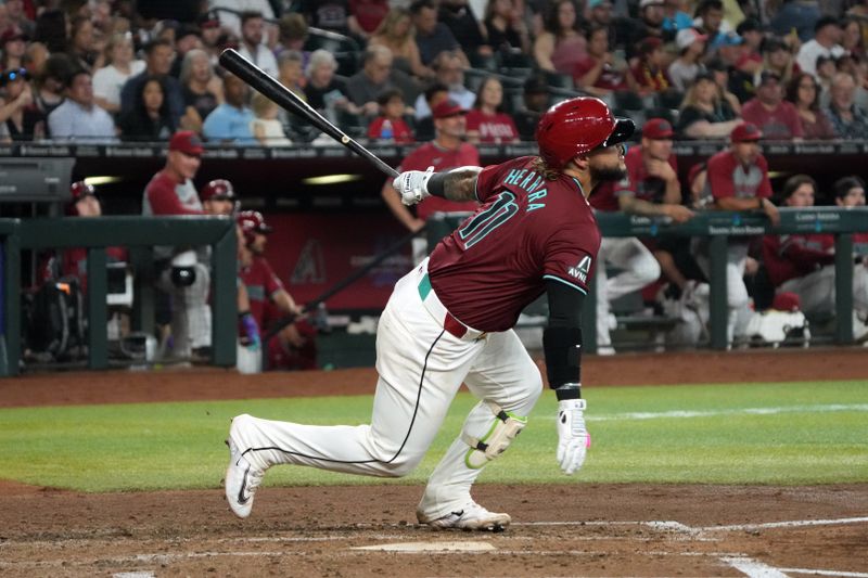 Jun 29, 2024; Phoenix, Arizona, USA; Arizona Diamondbacks catcher Jose Herrera (11) hits a single against the Oakland Athletics in the fourth inning at Chase Field. Mandatory Credit: Rick Scuteri-USA TODAY Sports