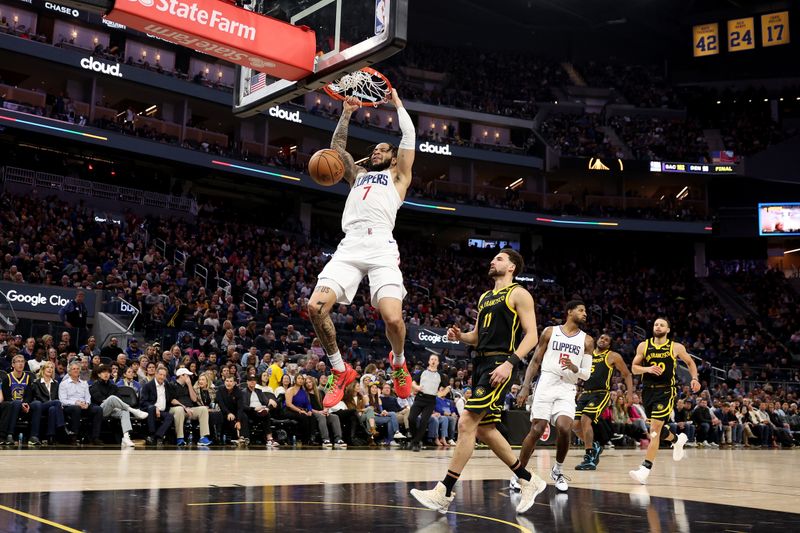 SAN FRANCISCO, CALIFORNIA - FEBRUARY 14: Amir Coffey #7 of the LA Clippers dunks the ball on Klay Thompson #11 of the Golden State Warriors  in the second half at Chase Center on February 14, 2024 in San Francisco, California. NOTE TO USER: User expressly acknowledges and agrees that, by downloading and or using this photograph, User is consenting to the terms and conditions of the Getty Images License Agreement.  (Photo by Ezra Shaw/Getty Images)