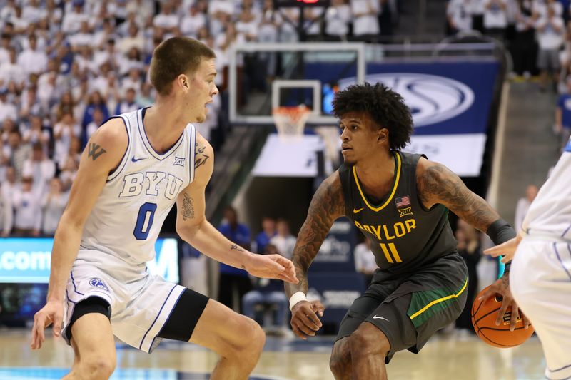 Feb 20, 2024; Provo, Utah, USA; Baylor Bears forward Jalen Bridges (11) dribbles the ball against Brigham Young Cougars forward Noah Waterman (0) during the first half at Marriott Center. Mandatory Credit: Rob Gray-USA TODAY Sports