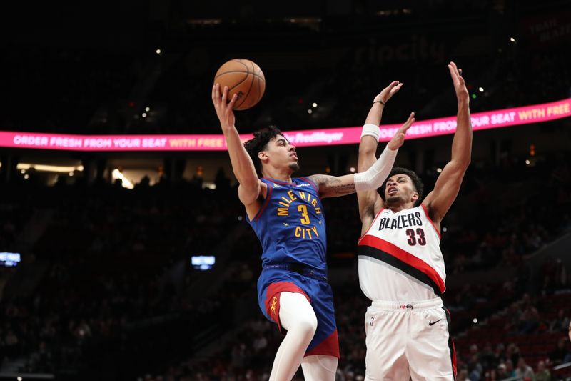 PORTLAND, OREGON - FEBRUARY 23: Julian Strawther #3 of the Denver Nuggets drives to the basket as Toumani Camara #33 of the Portland Trail Blazers defends during the fourth quarter at Moda Center on February 23, 2024 in Portland, Oregon. NOTE TO USER: User expressly acknowledges and agrees that, by downloading and or using this photograph, User is consenting to the terms and conditions of the Getty Images License Agreement.? (Photo by Amanda Loman/Getty Images)