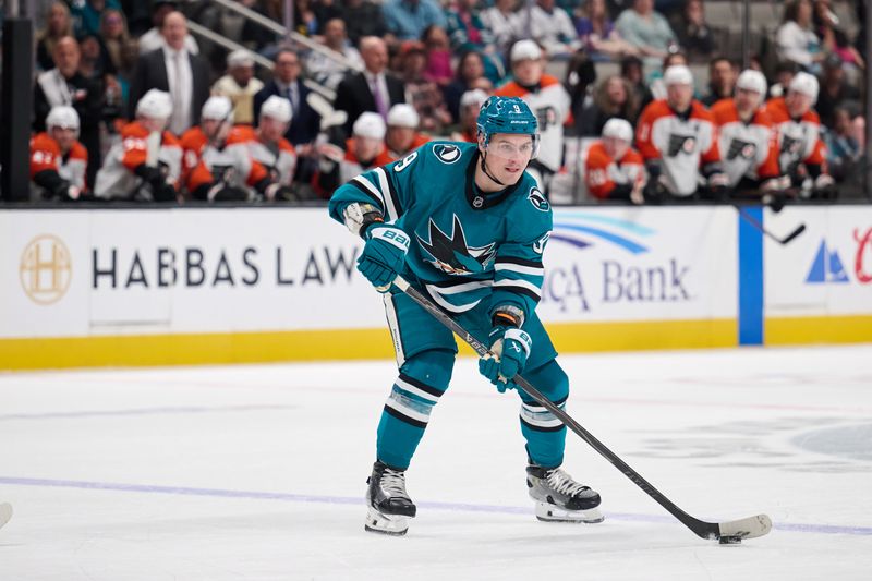 Mar 21, 2026; San Jose, California, USA; San Jose Sharks defender Dmitry Orlov (9) plays the puck against Philadelphia Flyers during the second period at SAP Center at San Jose. Mandatory Credit: Robert Edwards-Imagn Images