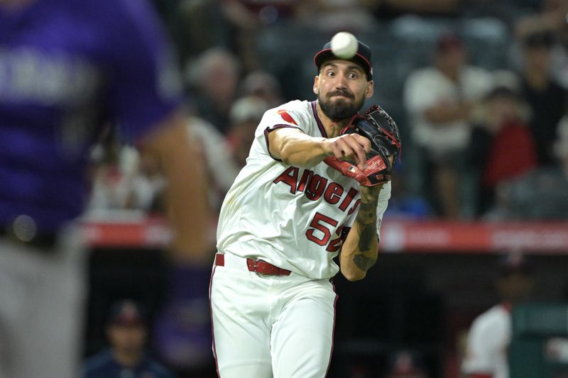 Aug 1, 2024; Anaheim, California, USA;  A throwing error by Los Angeles Angels relief pitcher Hans Crouse (52) off a bunt Colorado Rockies center fielder Sam Hilliard (16) allowed second baseman Aaron Schunk (30) to score the winning run in the tenth inning at Angel Stadium. Mandatory Credit: Jayne Kamin-Oncea-USA TODAY Sports