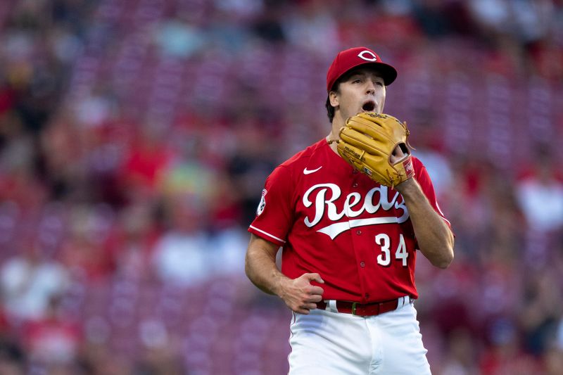 Sep 23, 2023; Cincinnati, Ohio, USA;  Cincinnati Reds starting pitcher Connor Phillips (34) reacts to striking out three batters in the first inning against the Pittsburgh Pirates at Great American Ball Park. Mandatory Credit: The Cincinnati Enquirer-USA TODAY Sports