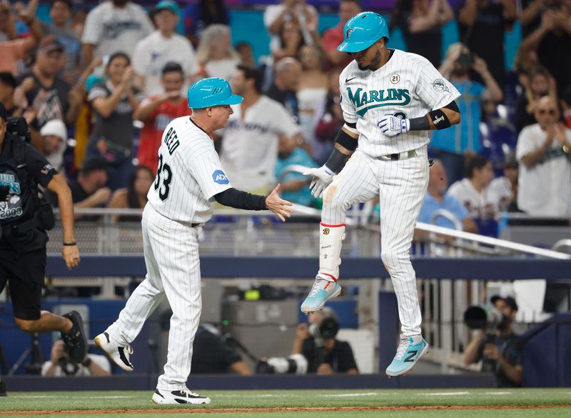 Sep 15, 2023; Miami, Florida, USA; Miami Marlins second baseman Luis Arraez (3) celebrates with Miami Marlins third base coach Jody Reed (33) after hitting his second home run of the night against the Atlanta Braves during the seventh inning at loanDepot Park. Mandatory Credit: Rhona Wise-USA TODAY Sports