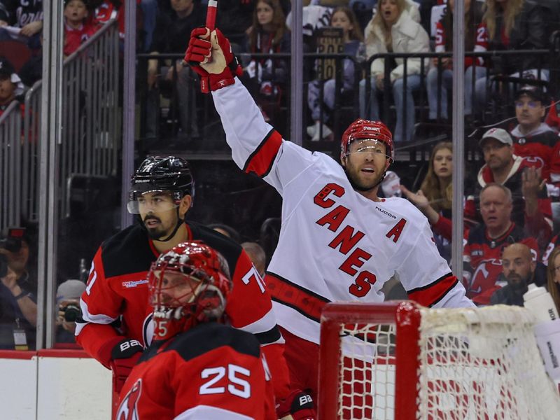 Apr 27, 2025; Newark, New Jersey, USA; Carolina Hurricanes defenseman Jaccob Slavin (74) celebrates his goal against the New Jersey Devils during the first period in game four of the first round of the 2025 Stanley Cup Playoffs at Prudential Center. Mandatory Credit: Ed Mulholland-Imagn Images