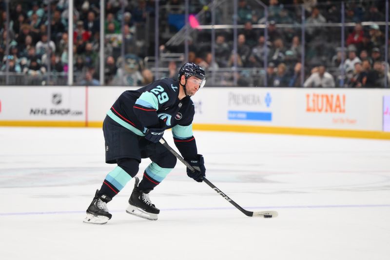 Mar 4, 2025; Seattle, Washington, USA; Seattle Kraken defenseman Vince Dunn (29) plays the puck during the third period against the Minnesota Wild at Climate Pledge Arena. Mandatory Credit: Steven Bisig-Imagn Images