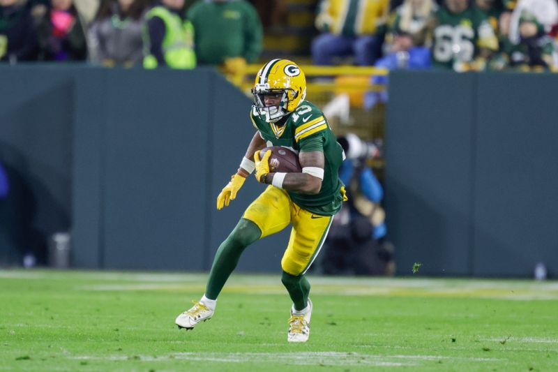 Green Bay Packers wide receiver Dontayvion Wicks (13) runs during an NFL football game between the Green Bay Packers and Chicago Bears Sunday, Jan. 7, 2024, in Green Bay, Wis. (AP Photo/Matt Ludtke)