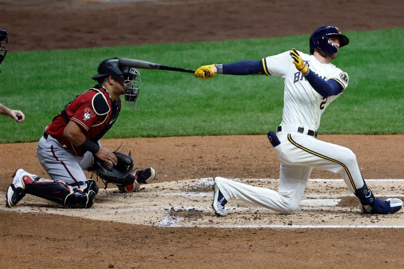 Oct 4, 2023; Milwaukee, Wisconsin, USA; Arizona Diamondbacks catcher Gabriel Moreno (14) is hit on a backswing by Milwaukee Brewers second baseman Brice Turang (2) in the second inning during game two of the Wildcard series for the 2023 MLB playoffs at American Family Field. Mandatory Credit: Kamil Krzaczynski-USA TODAY Sports