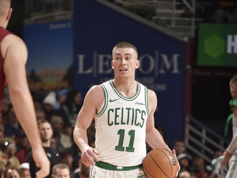 CLEVELAND, OH - DECEMBER 1: Payton Pritchard #11 of the Boston Celtics looks to pass the ball during the game against the Cleveland Cavaliers on December 1, 2024 at Rocket Mortgage FieldHouse in Cleveland, Ohio. NOTE TO USER: User expressly acknowledges and agrees that, by downloading and/or using this Photograph, user is consenting to the terms and conditions of the Getty Images License Agreement. Mandatory Copyright Notice: Copyright 2024 NBAE (Photo by David Liam Kyle/NBAE via Getty Images)