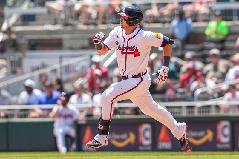 May 15, 2025; Cumberland, Georgia, USA; Atlanta Braves third base Austin Riley (27) runs after hitting a double against the Washington Nationals during the eighth inning at Truist Park. Mandatory Credit: Dale Zanine-Imagn Images