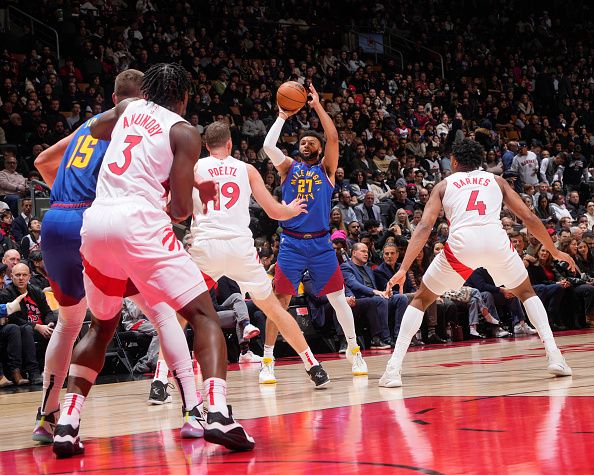 TORONTO, CANADA - DECEMBER 20:  Jamal Murray #27 of the Denver Nuggets passes the ball during the game  on December 20, 2023 at the Scotiabank Arena in Toronto, Ontario, Canada.  NOTE TO USER: User expressly acknowledges and agrees that, by downloading and or using this Photograph, user is consenting to the terms and conditions of the Getty Images License Agreement.  Mandatory Copyright Notice: Copyright 2023 NBAE (Photo by Mark Blinch/NBAE via Getty Images)