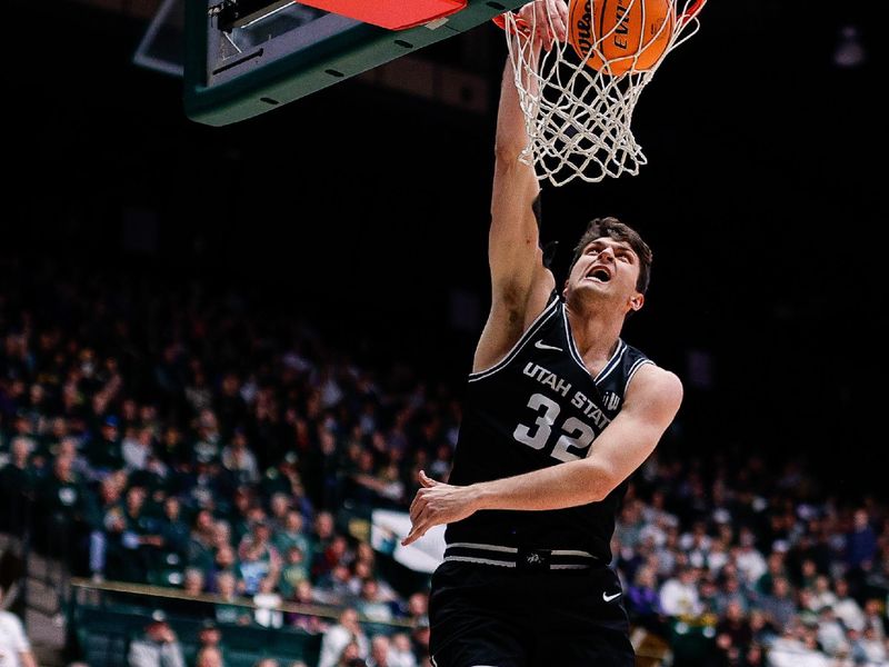 Feb 4, 2023; Fort Collins, Colorado, USA; Utah State Aggies center Trevin Dorius (32) dunks the ball against Colorado State Rams guard Joe Palmer (20) in the first half at Moby Arena. Mandatory Credit: Isaiah J. Downing-USA TODAY Sports