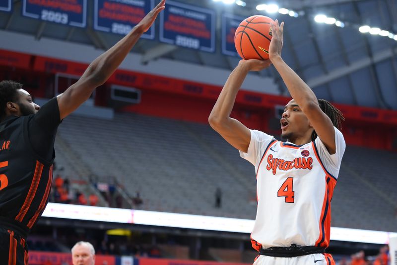 Jan 20, 2024; Syracuse, New York, USA; Syracuse Orange forward Chris Bell (4) shoots the ball as Miami (Fl) Hurricanes guard Wooga Poplar (left) defends during the second half at the JMA Wireless Dome. Mandatory Credit: Rich Barnes-USA TODAY Sports