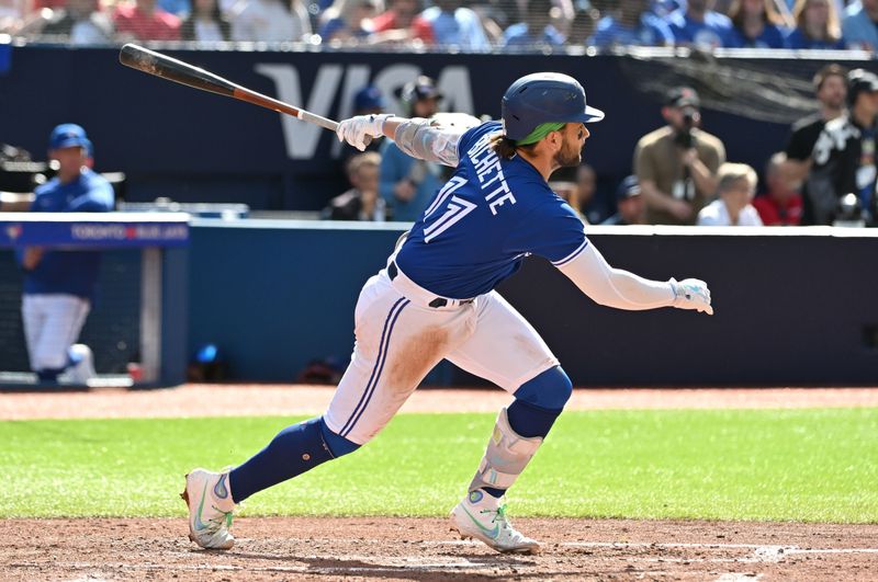 Jul 29, 2023; Toronto, Ontario, CAN;  Toronto Blue Jays shortstop Bo Bichette (11) hits a double against the Los Angeles Angels in the fifth inning at Rogers Centre. Mandatory Credit: Dan Hamilton-USA TODAY Sports