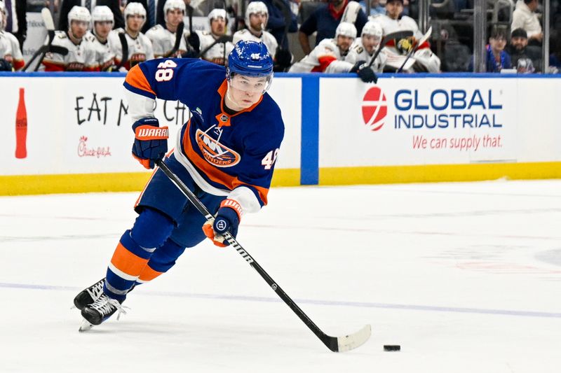 Mar 1, 2026; Elmont, New York, USA;  New York Islanders defenseman Matthew Schaefer (48) skates with the puck against the Florida Panthers during the first period at UBS Arena. Mandatory Credit: Dennis Schneidler-Imagn Images