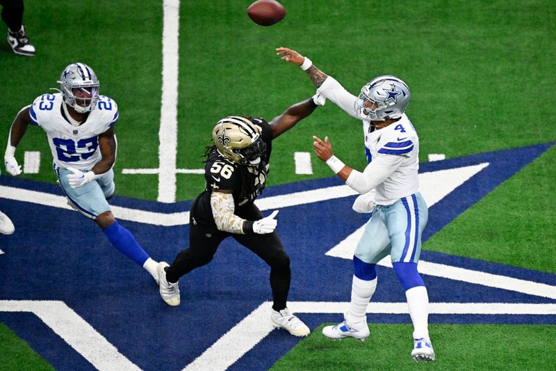 New Orleans Saints linebacker Demario Davis (56) applies pressure as Dallas Cowboys quarterback Dak Prescott, right, throws a pass during the first half of an NFL football game, Sunday, Sept. 15, 2024, in Arlington, Texas. Cowboys' Rico Dowdle (23) runs a route on the play. (AP Photo/Jerome Miron)