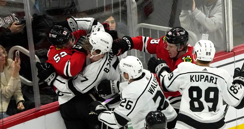 Jan 22, 2023; Chicago, Illinois, USA; Chicago Blackhawks center Reese Johnson (52) and Los Angeles Kings defenseman Tobias Bjornfot (7) skirmish during the first period at United Center. Mandatory Credit: David Banks-USA TODAY Sports