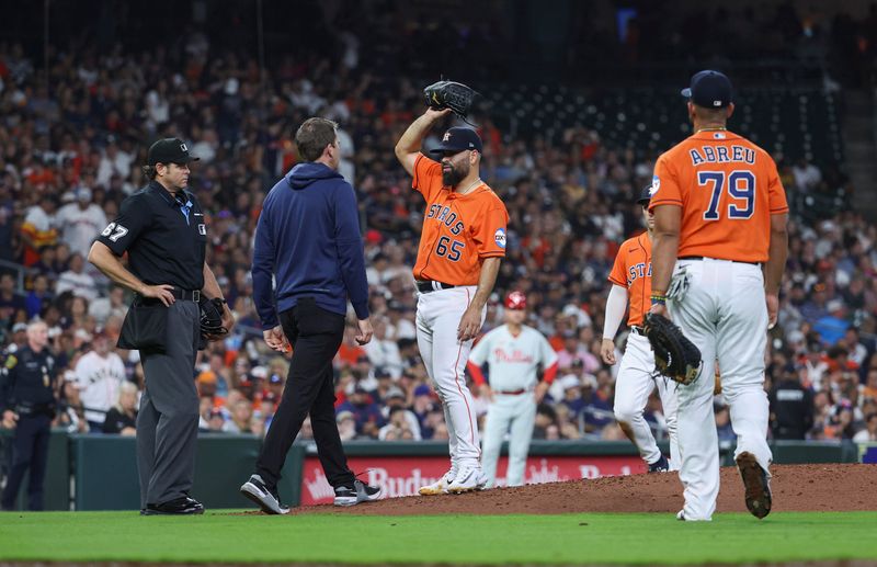 Apr 30, 2023; Houston, Texas, USA; Houston Astros starting pitcher Jose Urquidy (65) is evaluated by medical staff after an apparent injury during the sixth inning against the Philadelphia Phillies at Minute Maid Park. Mandatory Credit: Troy Taormina-USA TODAY Sports