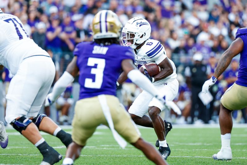 Sep 21, 2024; Seattle, Washington, USA; Northwestern Wildcats running back Joseph Himon II (6) rushes against the Washington Huskies during the third quarter at Alaska Airlines Field at Husky Stadium. Mandatory Credit: Joe Nicholson-Imagn Images