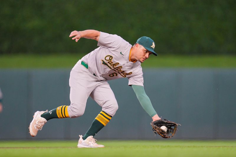 Jun 13, 2024; Minneapolis, Minnesota, USA; Oakland Athletics shortstop Aledmys Díaz (6) fields a ground ball against the Minnesota Twins in the eighth inning at Target Field. Mandatory Credit: Brad Rempel-USA TODAY Sports