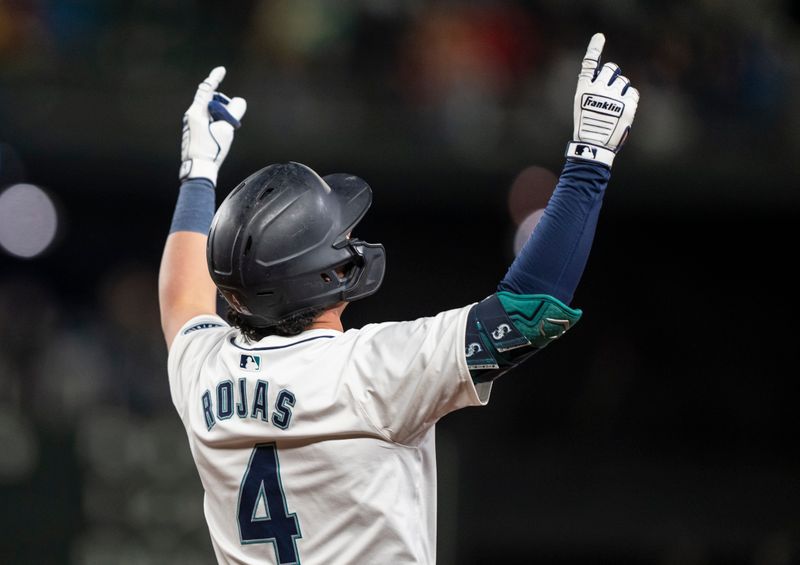 Apr 29, 2024; Seattle, Washington, USA; Seattle Mariners third baseman Josh Rojas (4) celebrates after hitting a single during the eighth inning against the Atlanta Braves at T-Mobile Park. Mandatory Credit: Stephen Brashear-USA TODAY Sports